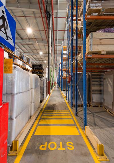 Pedestrian crossing a rack aisle in a warehouse